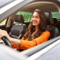 Happy,Young,Woman,Driving,Car,And,Smiling,,Enjoying,Automobile,Travel,